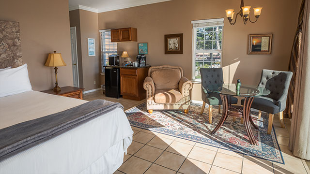 The Dunes Room Love Seat, Dining Table And King Bed At Mavericks
