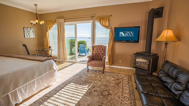 The Flat Rock Room Sitting Area And Gas Stove At Inn at Mavericks