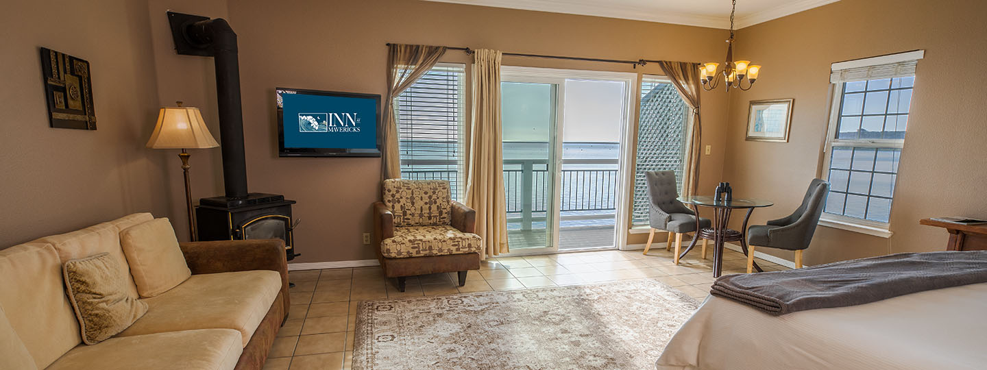 The Montara Room Sitting and Dining Area With Couch, Love Seat, Gas Stove and Dining Table