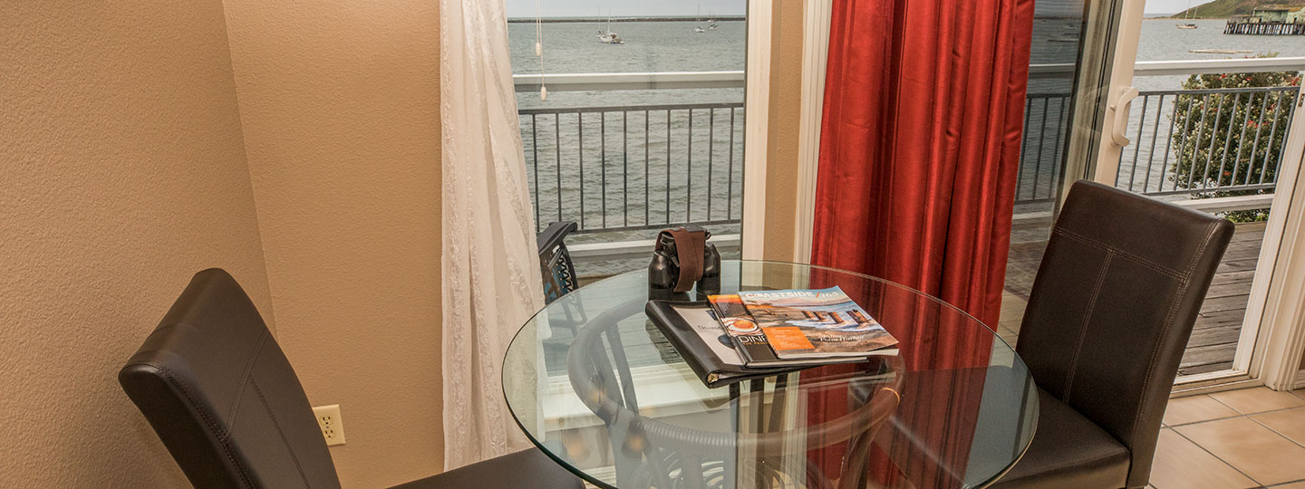 Ross' Cove Dining Area With Table And Ocean Views At Inn At Mavericks